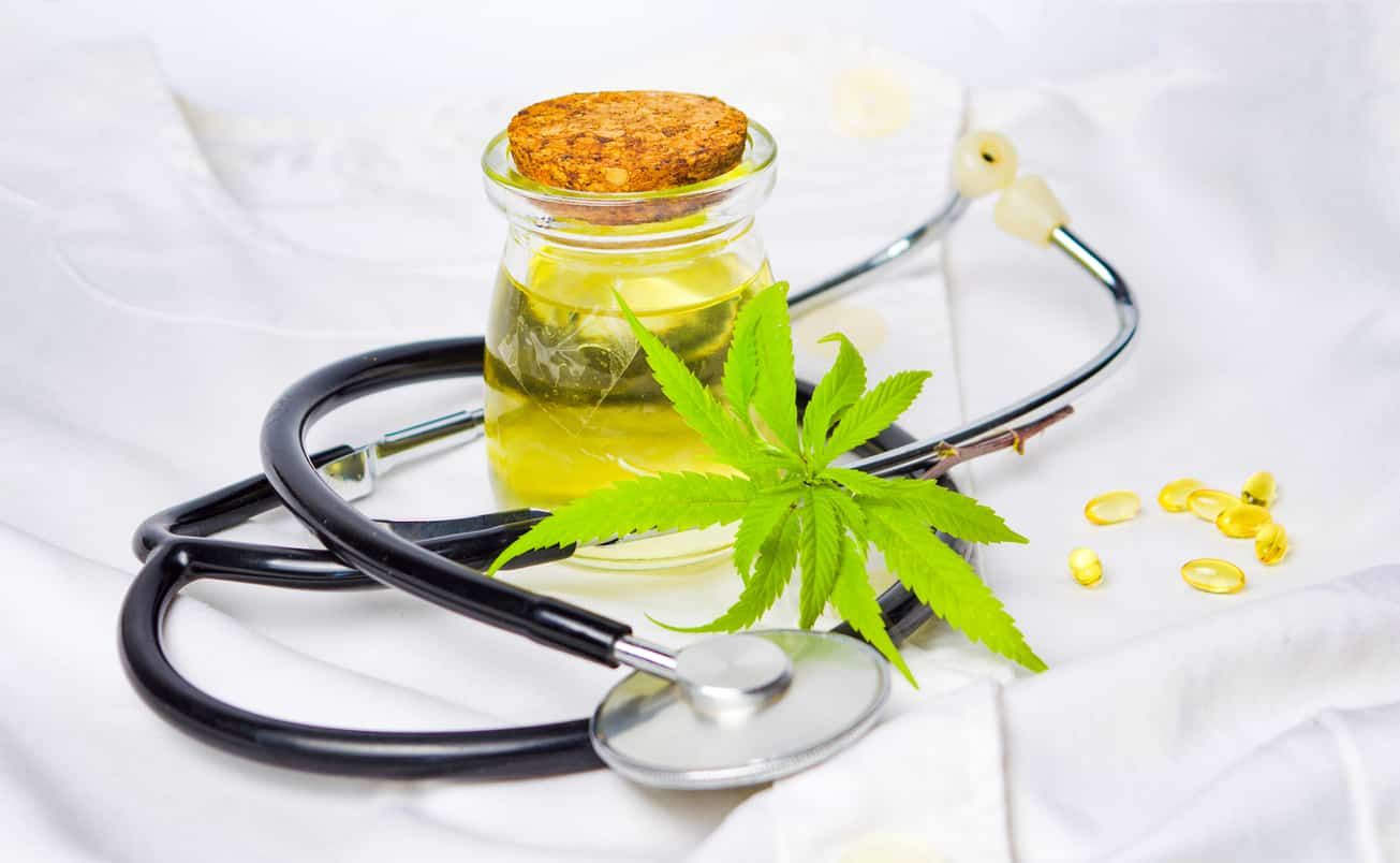 hemp-leaf-cbd-oil-and-stethoscope-arranged-on-white-linens hemp-leaf-cbd-oil-and-stethoscope-arranged-on-white-linens